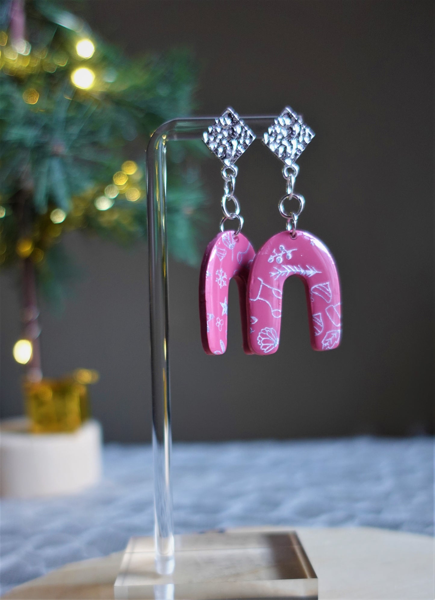 red arched earrings with silver components and silver stenciled pattern