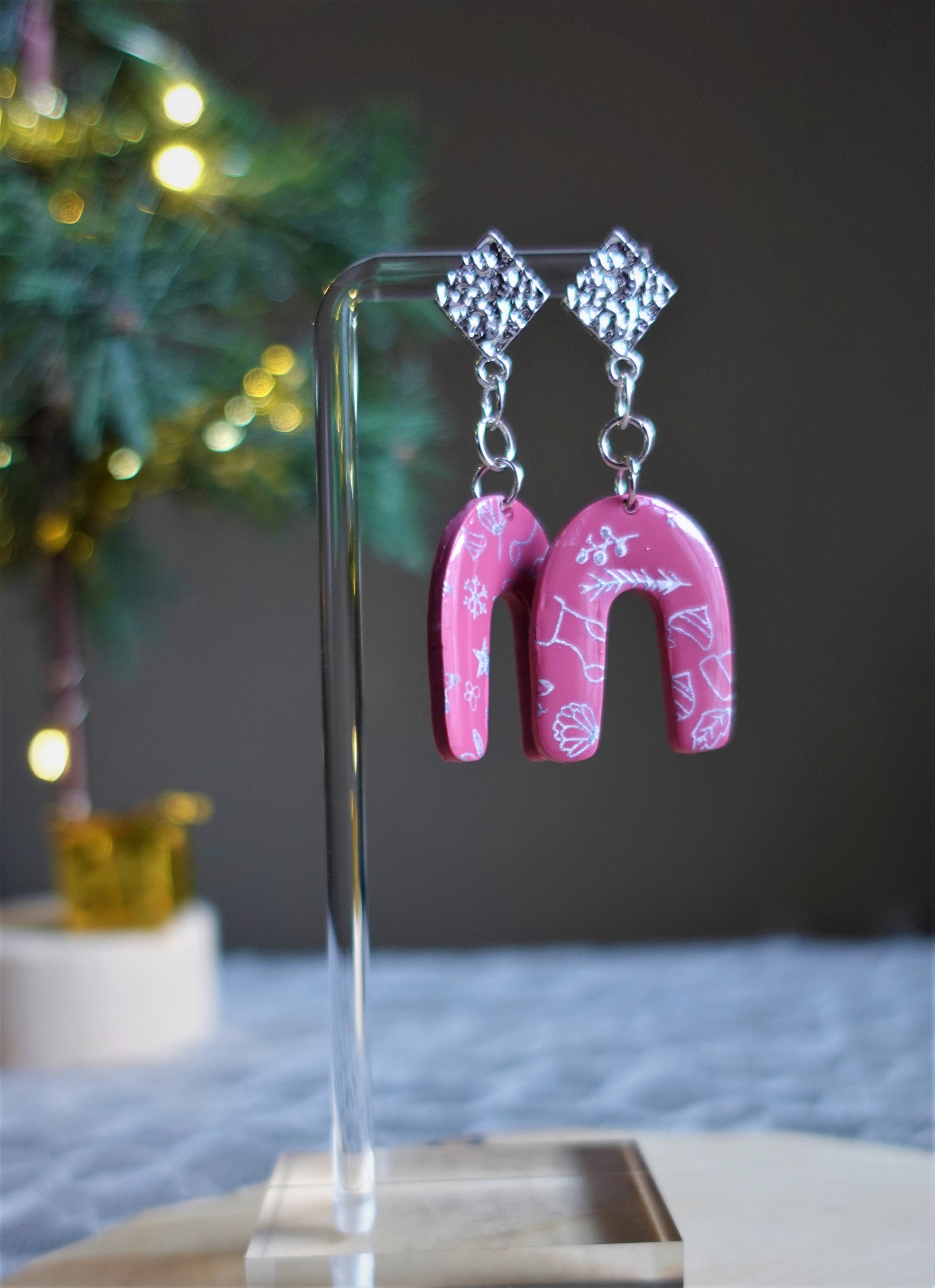 red arched earrings with silver components and silver stenciled pattern