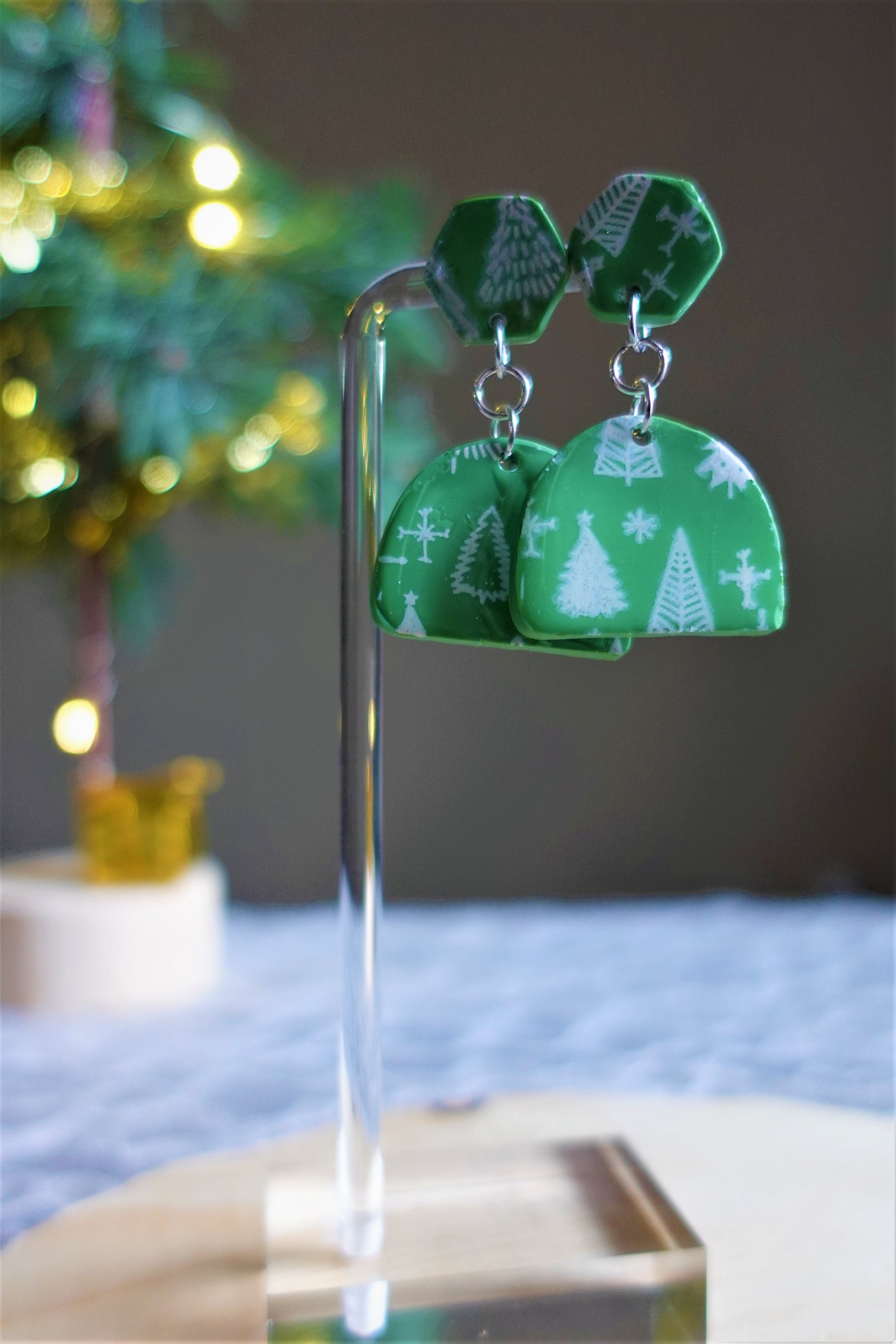 green earrings with white Christmas trees stenciled and silver components