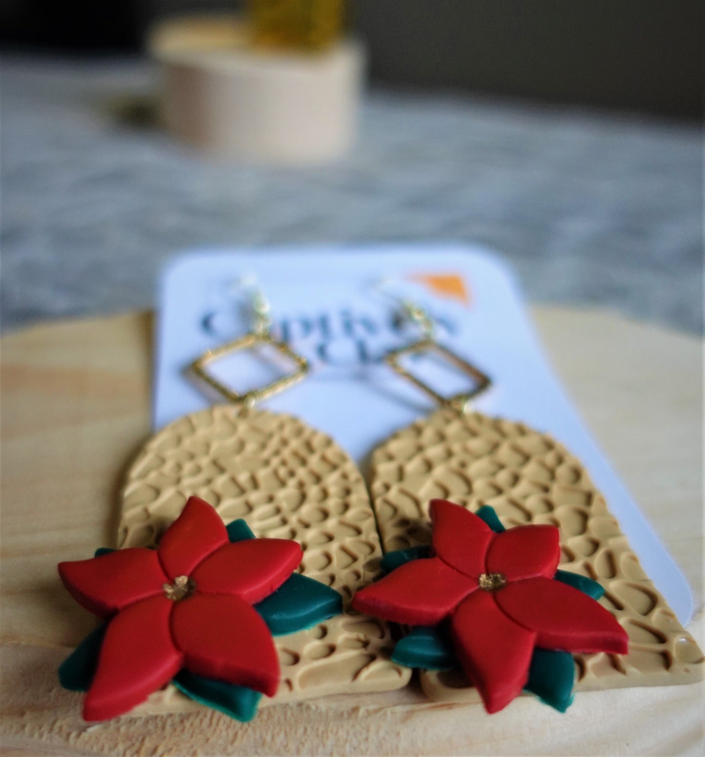 beige earrings with red and green 3d poinsettias and gold components