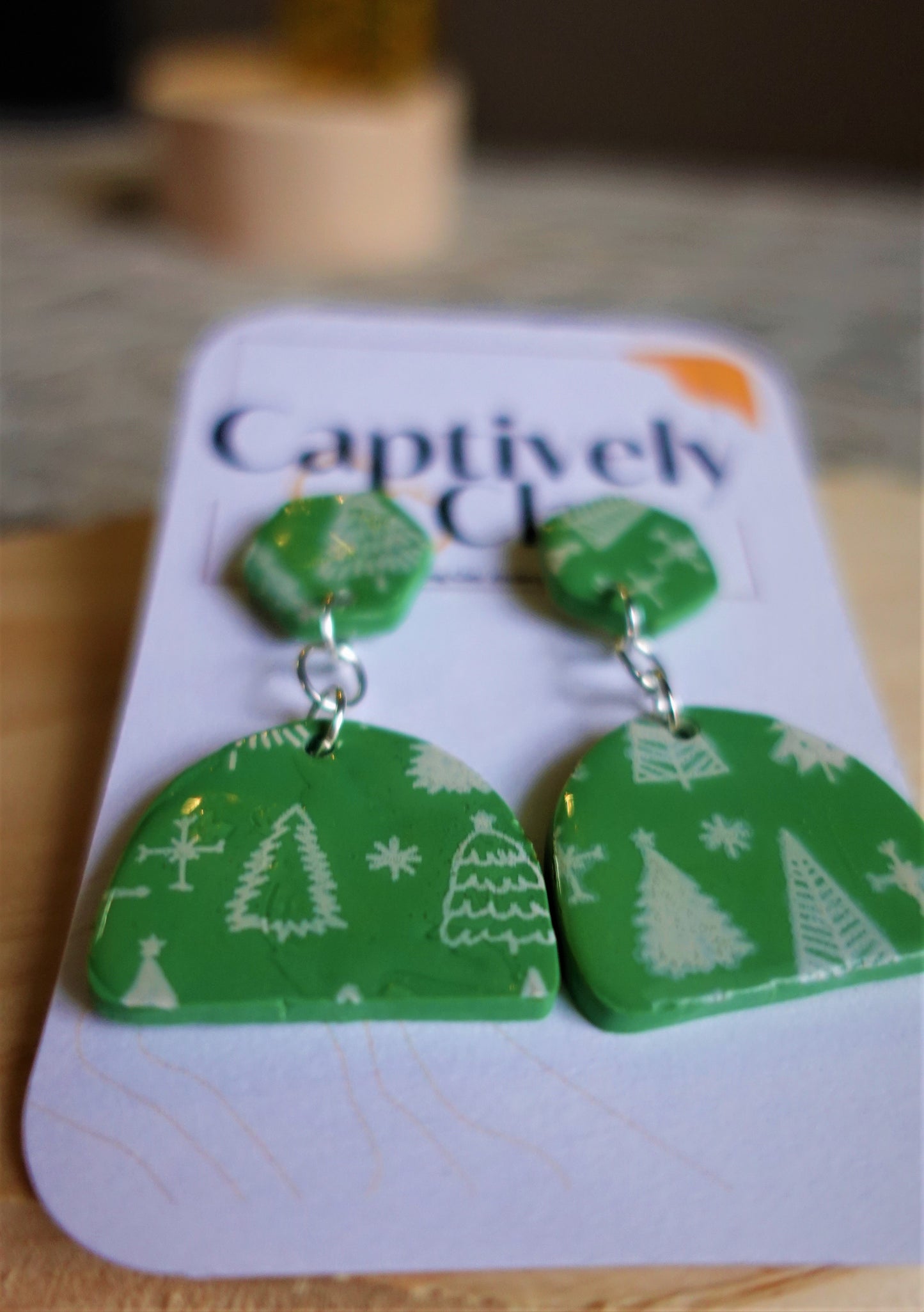 green earrings with white Christmas trees stenciled and silver components