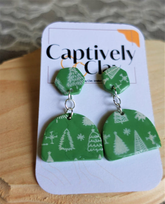 green earrings with white Christmas trees stenciled and silver components