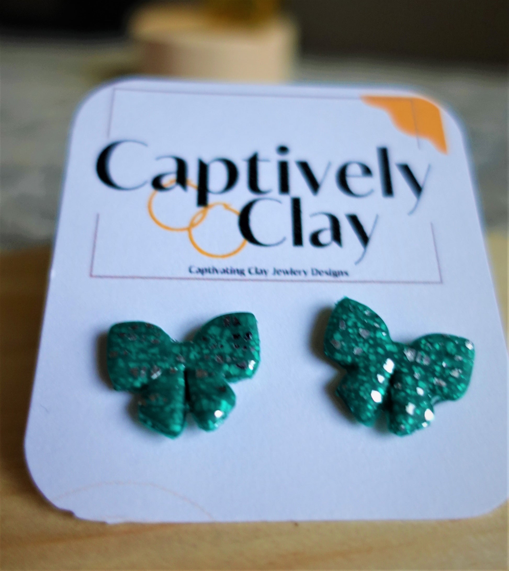 green christmas bow studs with silver glitter