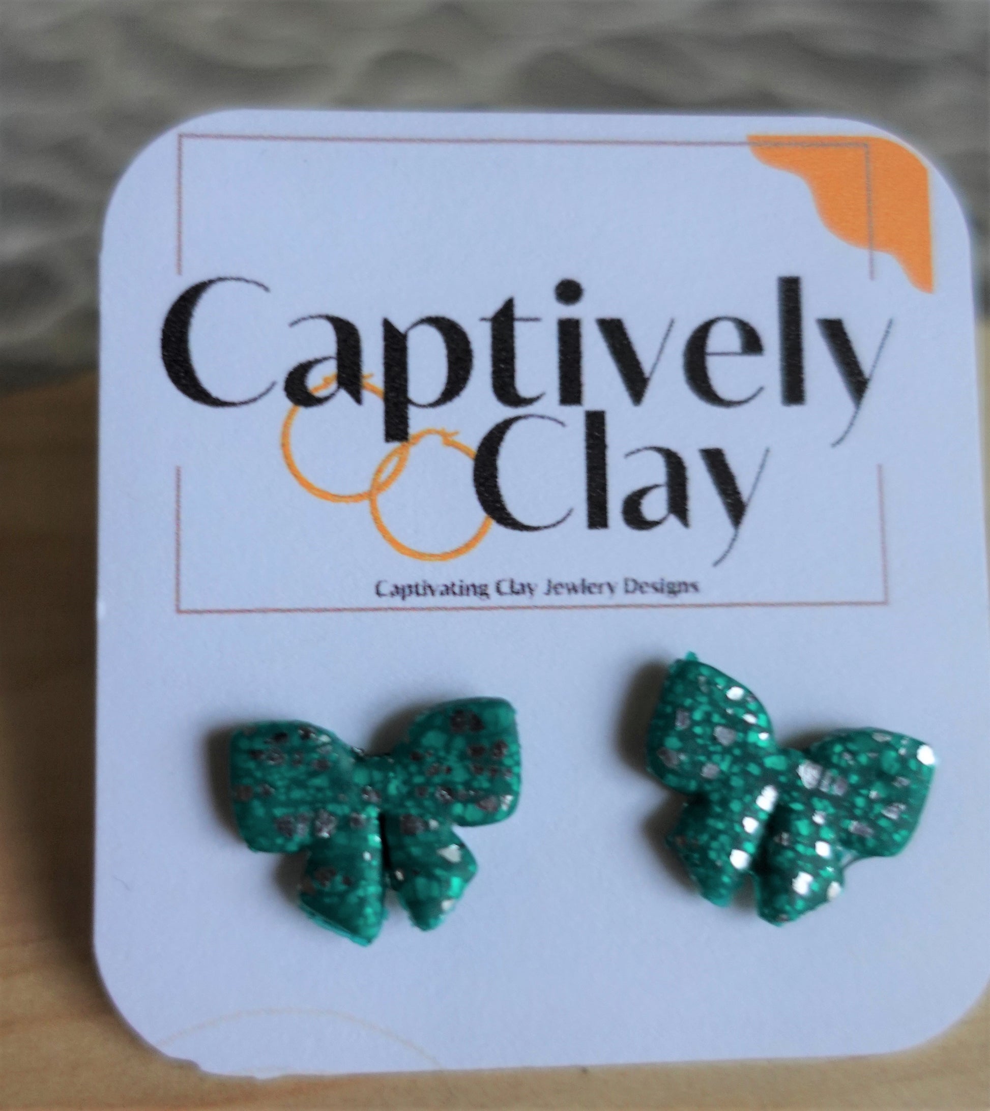 green christmas bow studs with silver glitter